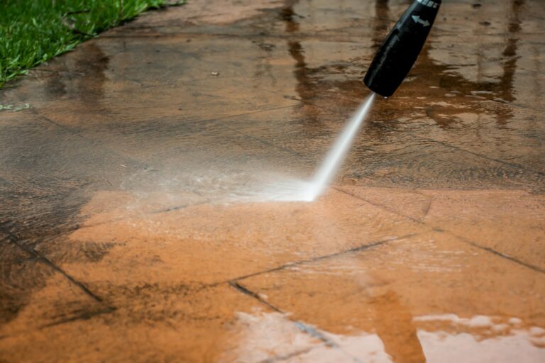 Cleaning backyard with pressure washer. Spring clean up