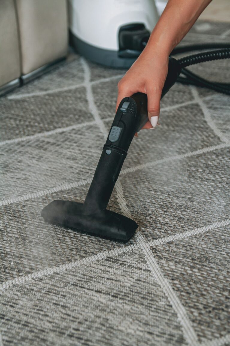 Woman cleaning carpet with a steam cleaner